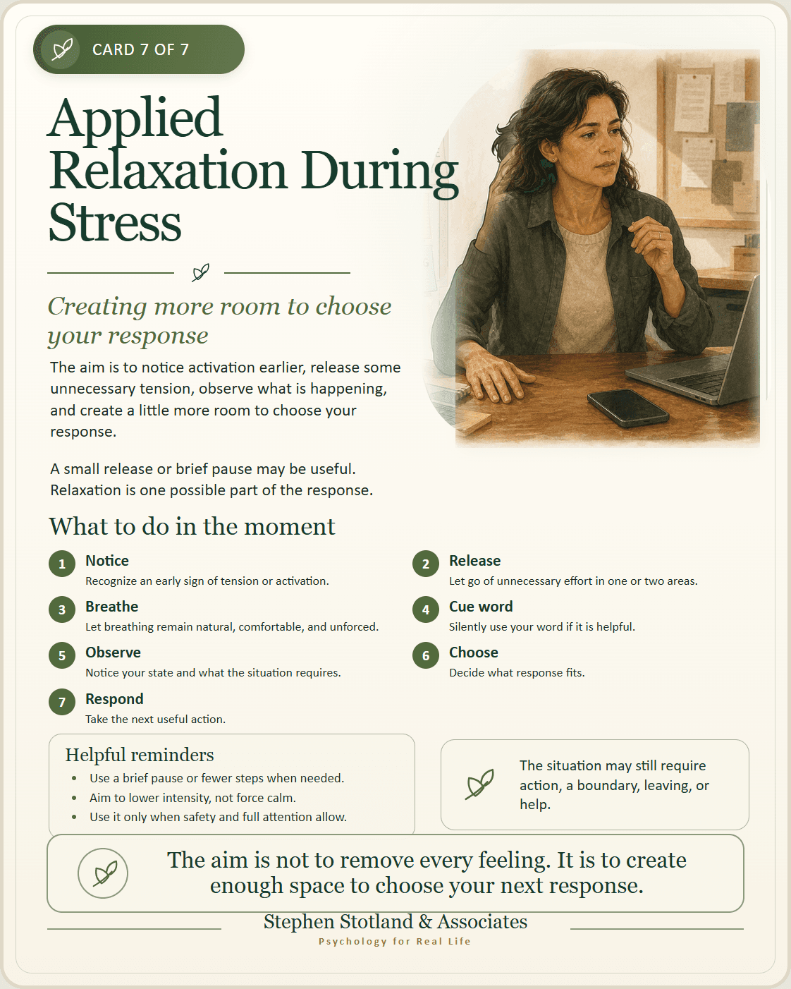 Woman at a desk noticing stress and pausing before responding to a phone or laptop.